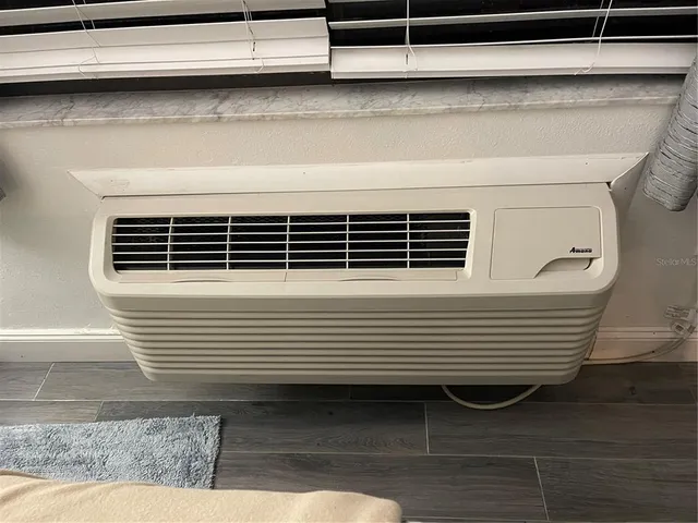 a balcony with chairs and a potted plant