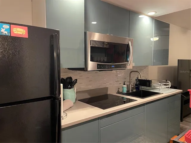 a kitchen with a sink and a refrigerator