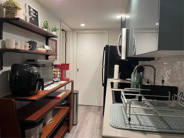 a kitchen with wooden cabinets and appliances