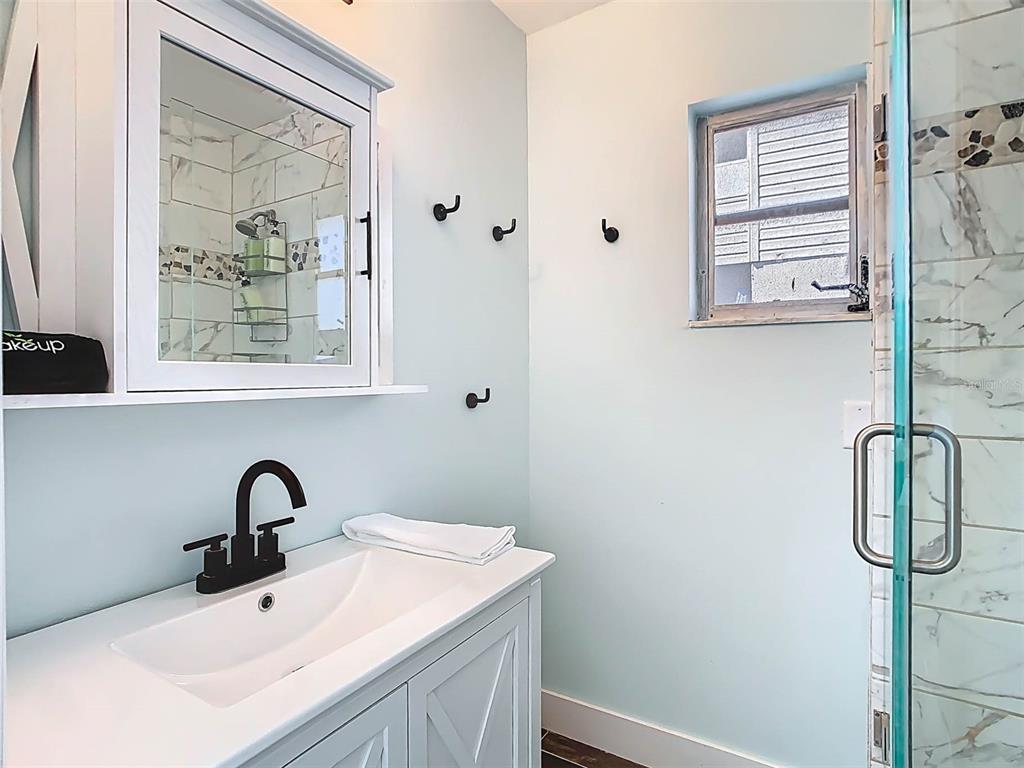 4984 Cedarbrook Lane Hernando Beach, FL 34607 - Photo 41 of 65 a bathroom with a sink and a window
