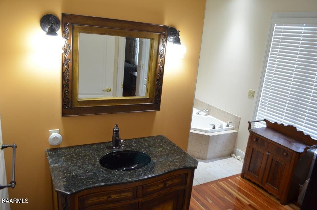 13 Hampton Point Crossville, TN 38558 - Photo 22 of 45 a bathroom with a granite countertop sink and a toilet