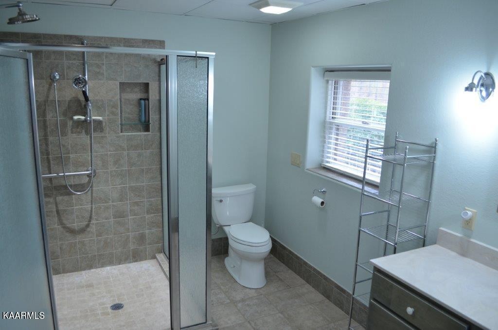 13 Hampton Point Crossville, TN 38558 - Photo 33 of 45 a bathroom with a granite countertop sink a toilet and shower