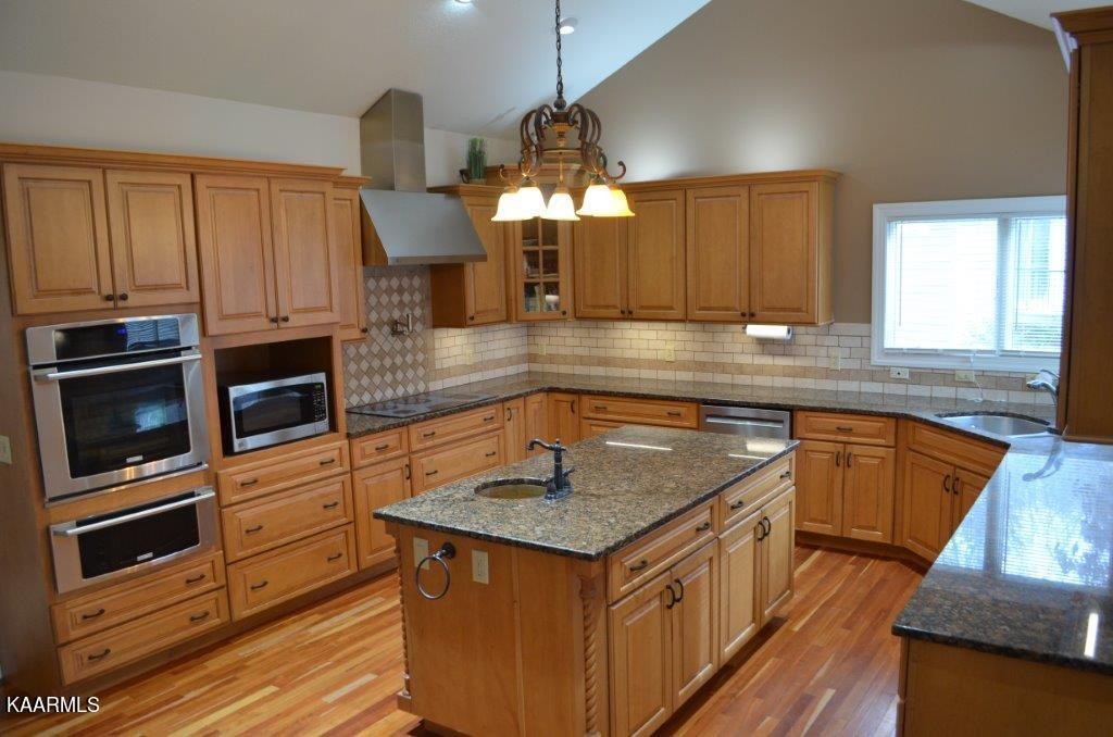 13 Hampton Point Crossville, TN 38558 - Photo 6 of 45 a kitchen with stainless steel appliances granite countertop a sink dishwasher a stove and a microwave oven with granite countertops
