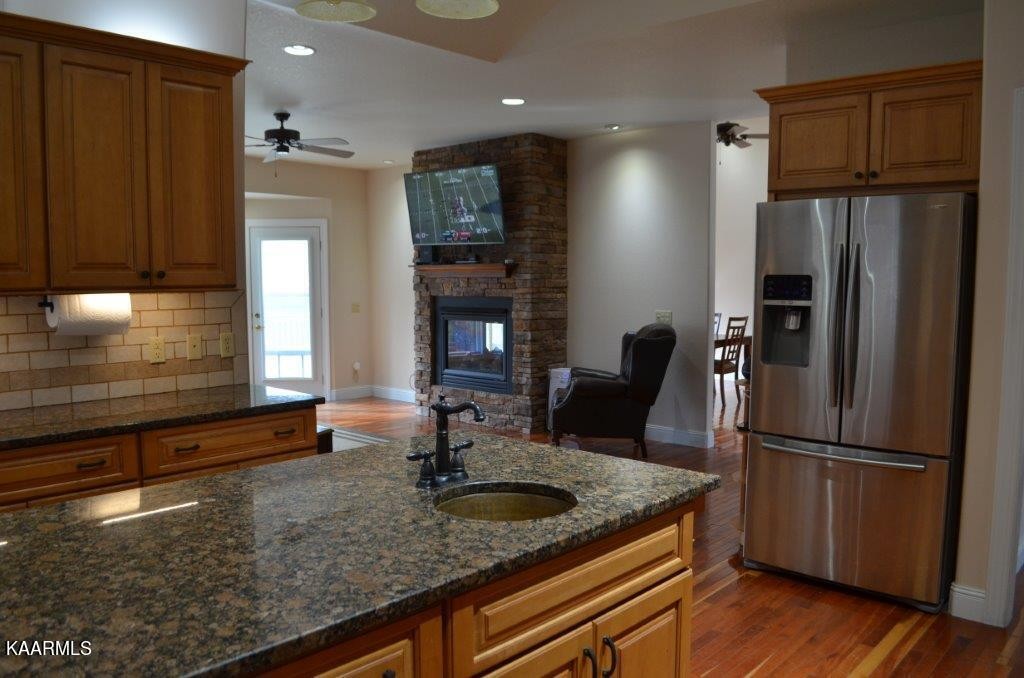 13 Hampton Point Crossville, TN 38558 - Photo 10 of 45 a kitchen with granite countertop a refrigerator a sink and wooden cabinets