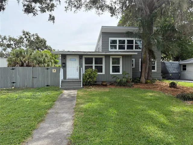 a view of backyard of house with green space