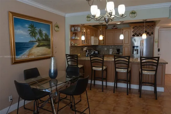 a view of a dining room with furniture and a chandelier