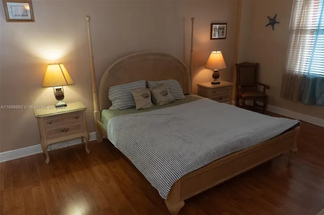 a bed sitting in a bedroom next to a lamp