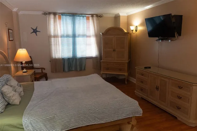 a bedroom with a bed and a television