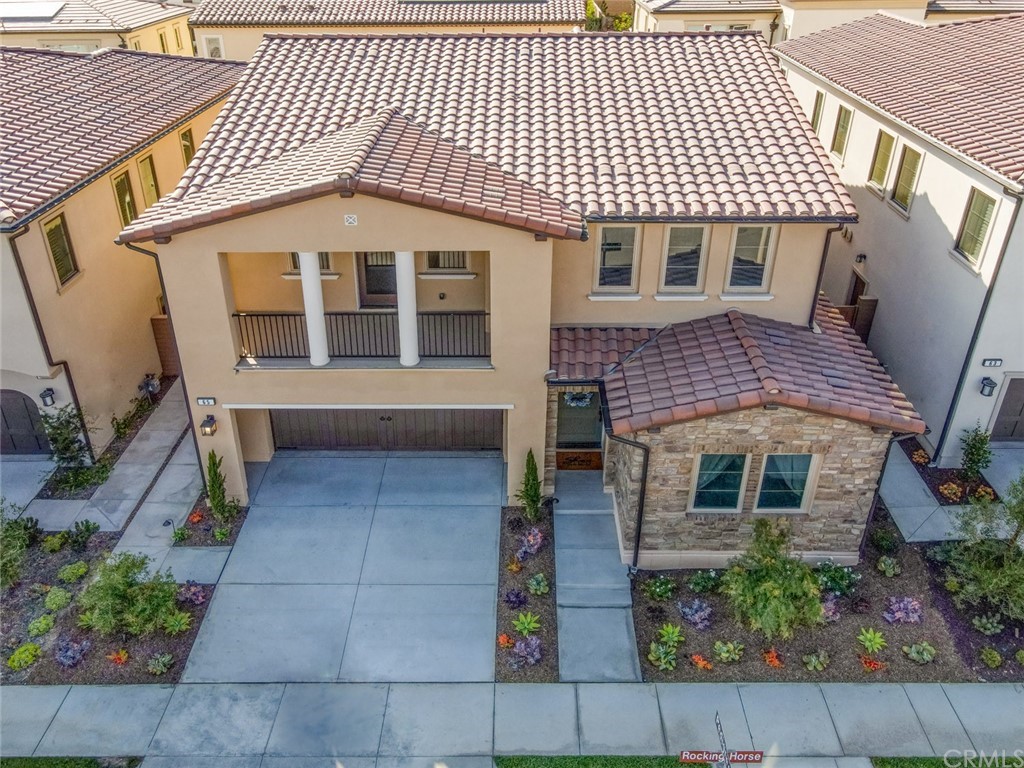 65 Rockinghorse Irvine, CA 92602 - Photo 2 of 43 a front view of a house with a balcony