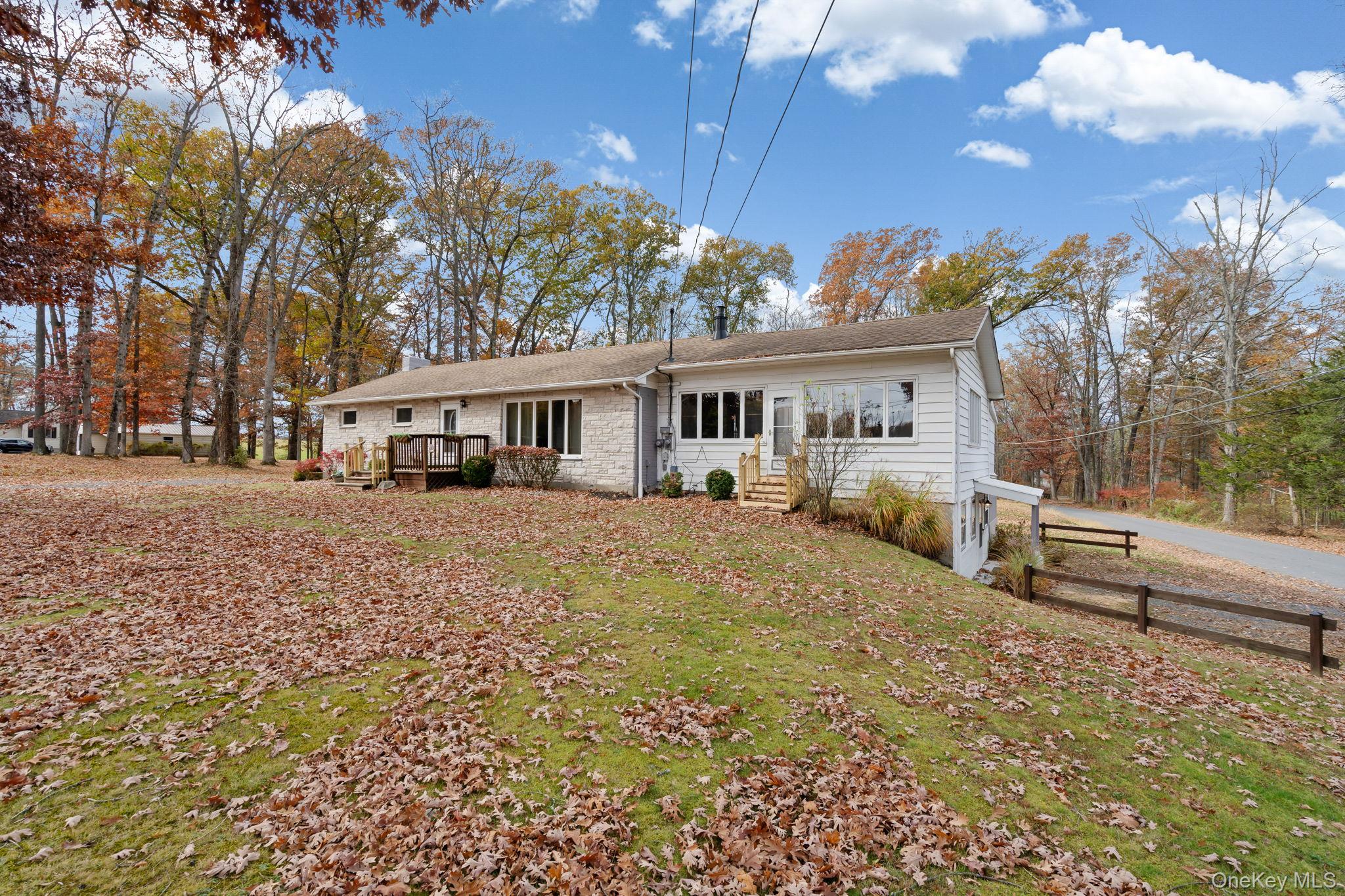 7 Red Top Road, Unit 2 Wallkill, NY 12589 - Photo 2 of 24 a view of a white house next to a yard with plants and trees