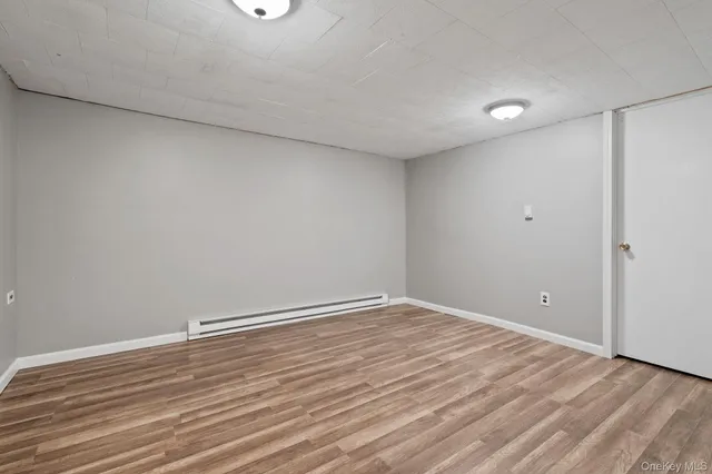 a view of room with wooden floor