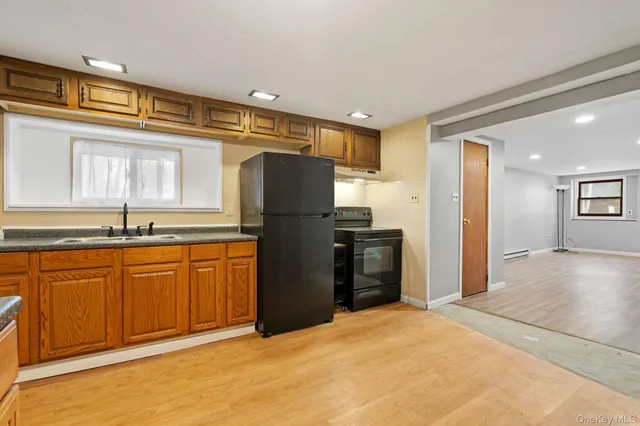 a kitchen with stainless steel appliances granite countertop a refrigerator and a sink