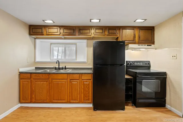 a kitchen with stainless steel appliances granite countertop a refrigerator and a sink