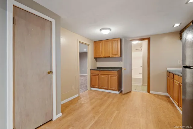 a view of a kitchen with a sink and a refrigerator