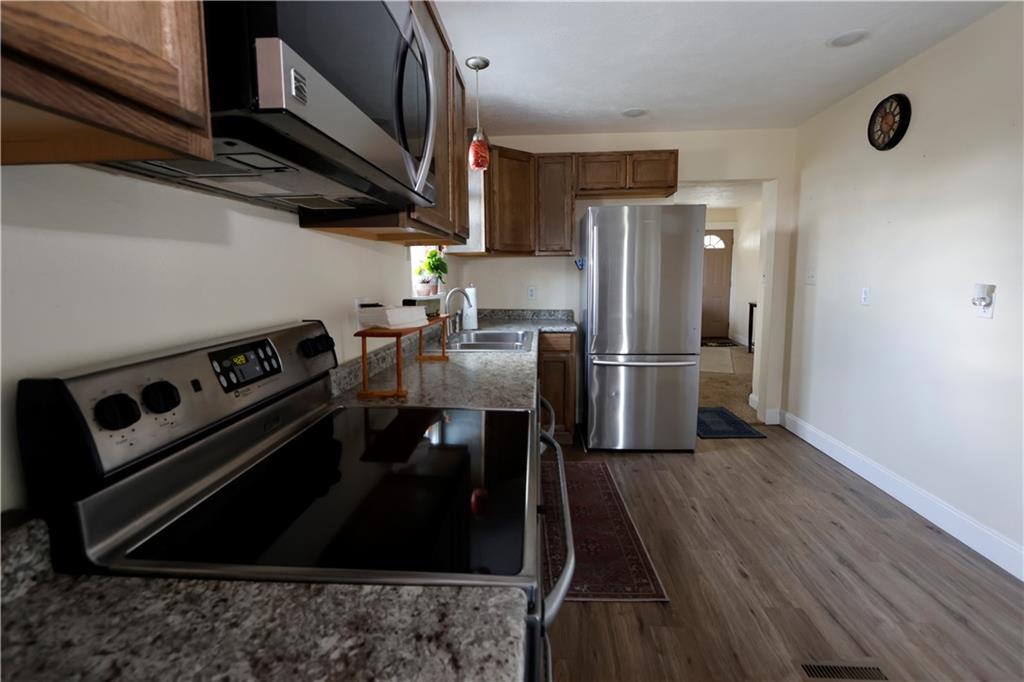 110 Blanche Road Fredericktown, PA 15333 - Photo 12 of 39 a kitchen with stainless steel appliances granite countertop a refrigerator a stove and a wooden floors
