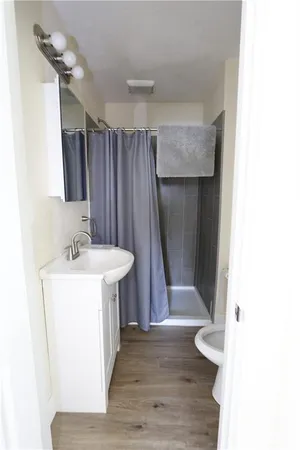 a bathroom with a sink a mirror and shower