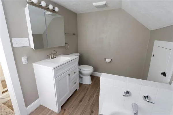 a bathroom with a sink a toilet and a mirror