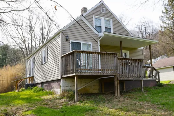 a view of a house with a yard and sitting area