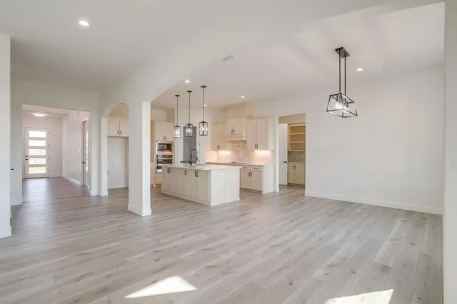 a view of a kitchen with wooden floor and a sink