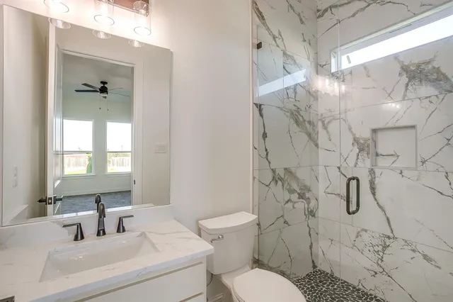 a bathroom with a sink toilet and shower