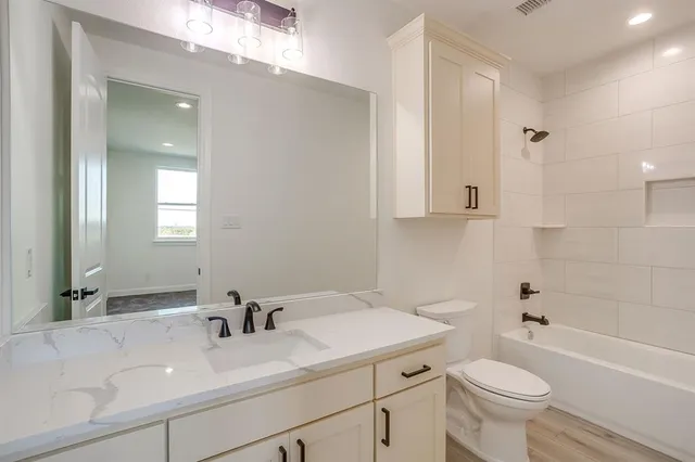 a bathroom with a sink a toilet and a bathtub