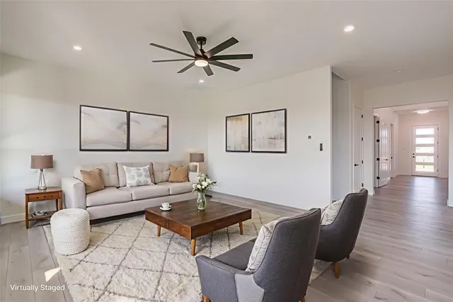 a living room with furniture a window and a lamp