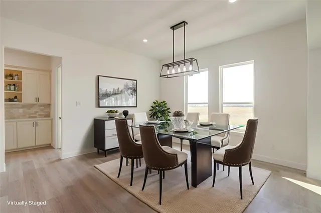 a view of a dining room with furniture window and wooden floor