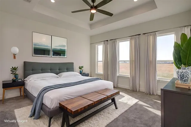 a bedroom with a bed window and a flat screen tv