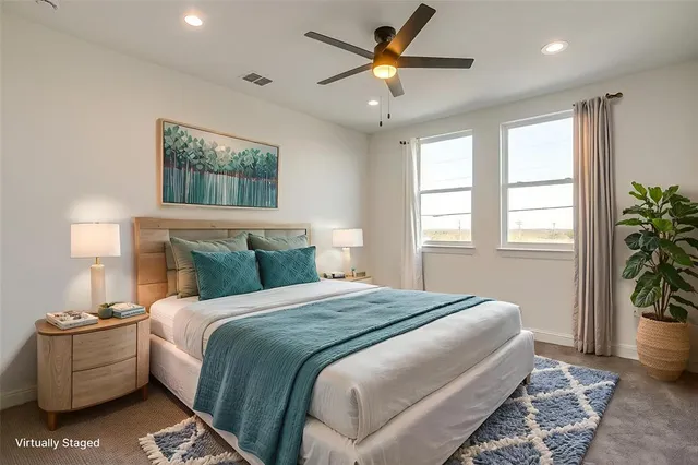 a bedroom with a large bed and a window