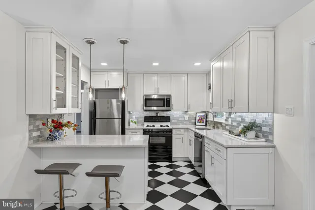 a kitchen with a sink a refrigerator and cabinets