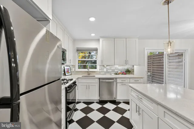 a kitchen with a sink stove and microwave