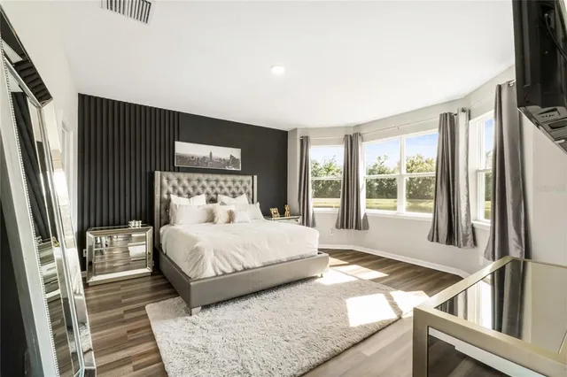 a bathroom with a sink toilet double vanity and shower
