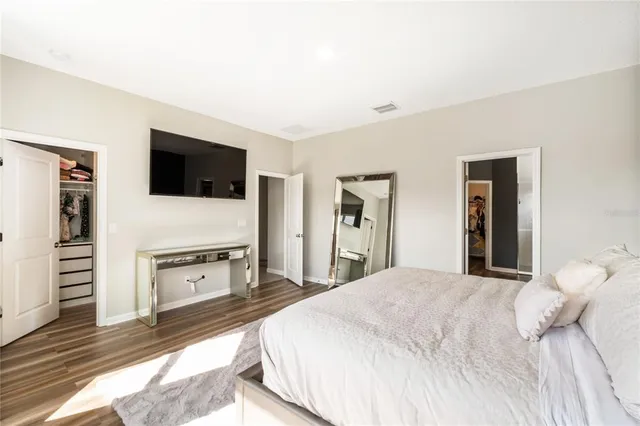 a bedroom with two beds and a large window