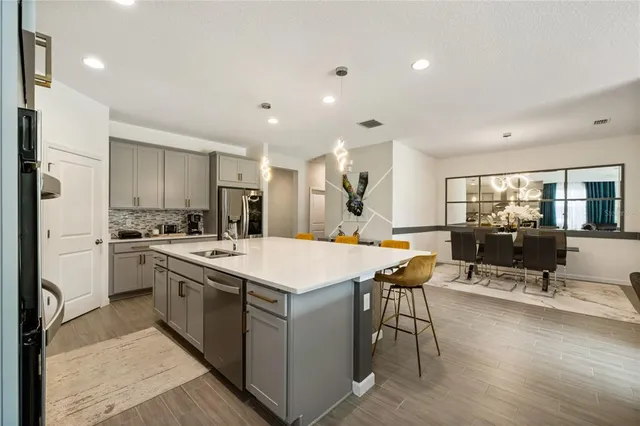 a kitchen with stainless steel appliances granite countertop a stove and a sink