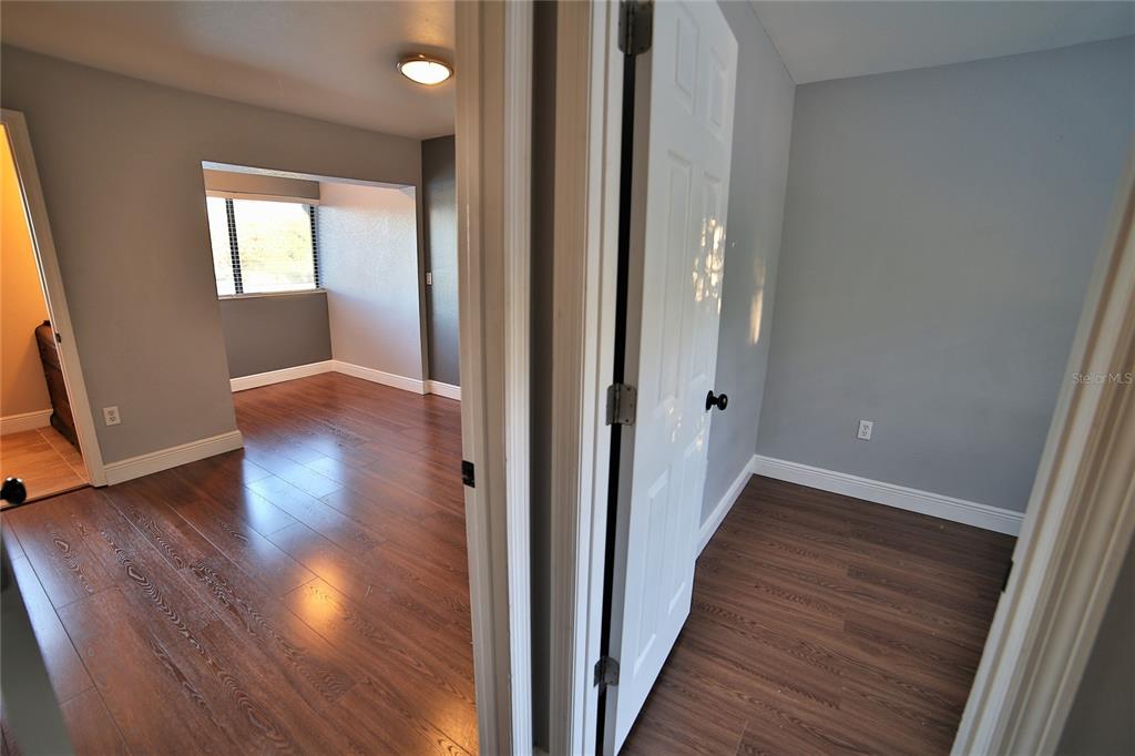 10260 Turkey Lake Road, Unit 149 Orlando, FL 32819 - Photo 12 of 18 a view of hallway with wooden floor