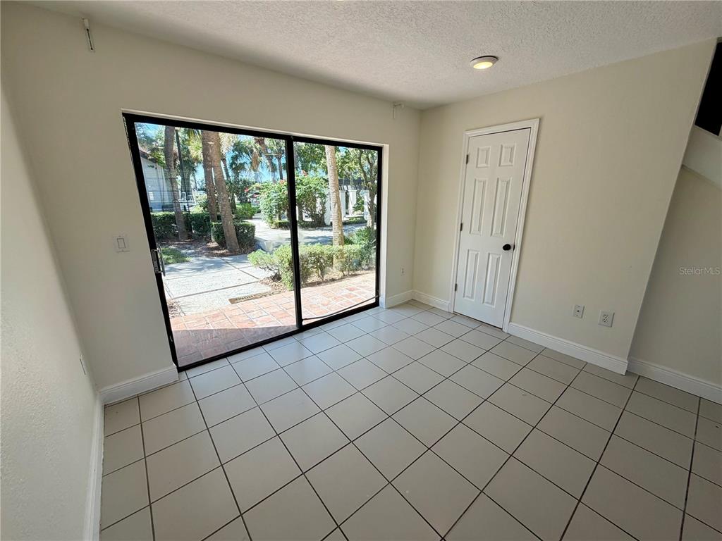 10260 Turkey Lake Road, Unit 149 Orlando, FL 32819 - Photo 8 of 18 a view of empty room with wooden floor and fan
