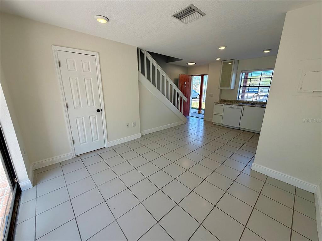 10260 Turkey Lake Road, Unit 149 Orlando, FL 32819 - Photo 9 of 18 an empty room & wooden floor and windows