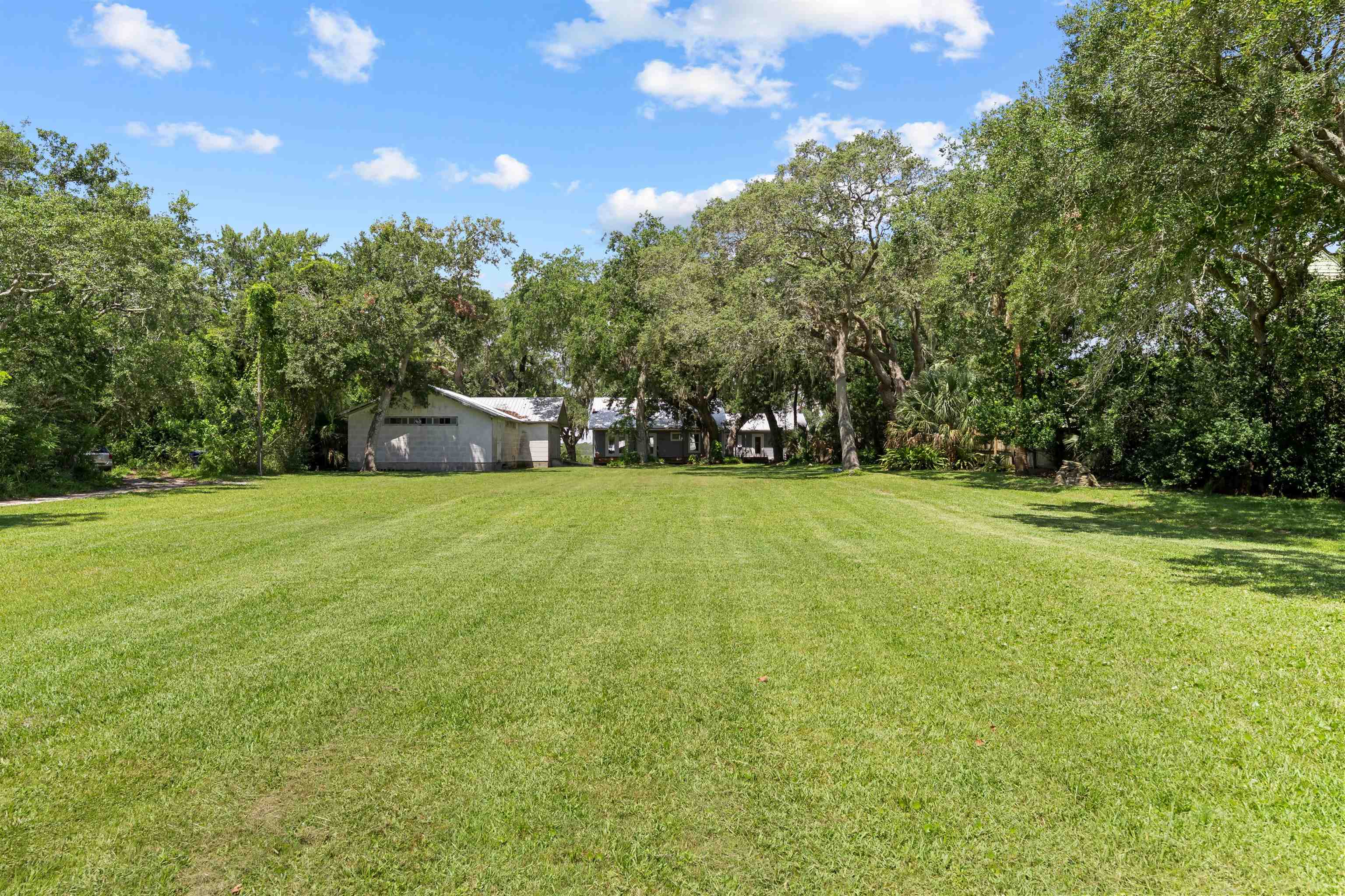 5425 A Windantide Road St. Augustine, FL 32080 - Photo 1 of 10 a view of green field with trees in the background