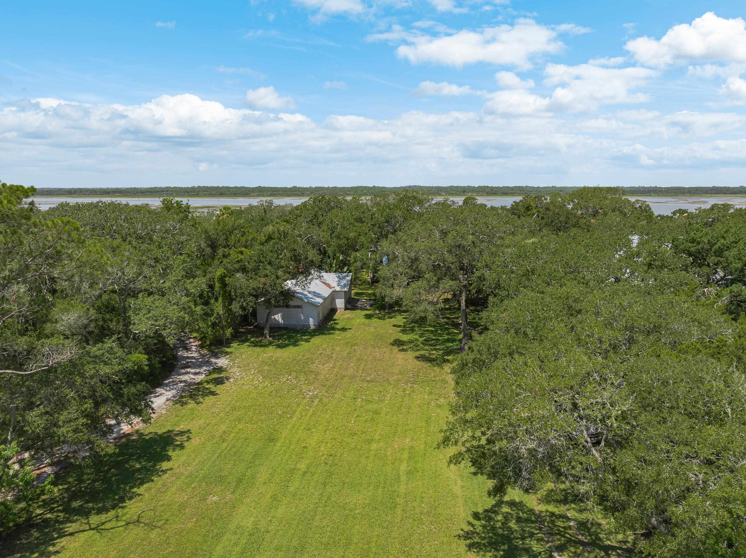 5425 A Windantide Road St. Augustine, FL 32080 - Photo 8 of 10 a view of a yard with an trees