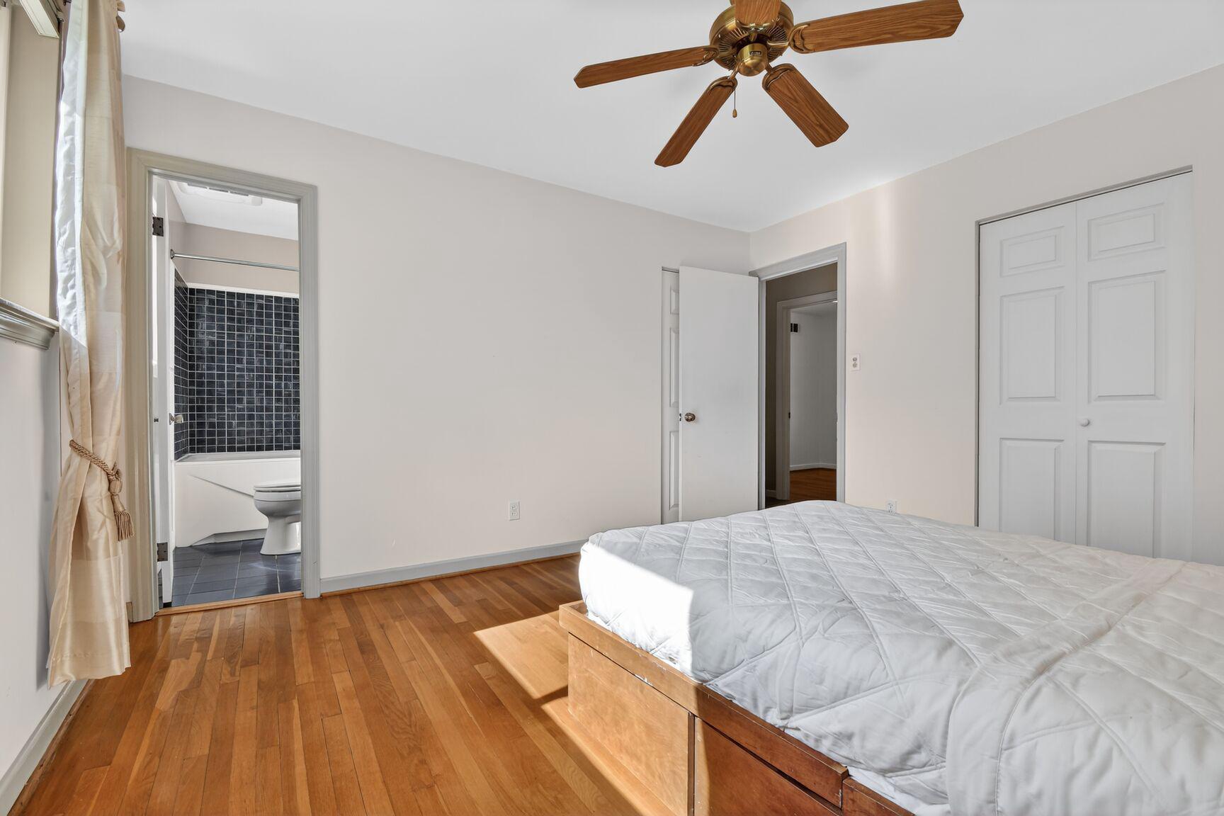 10226 Leslie Street Silver Spring, MD 20910 - Photo 14 of 32 a bedroom with a bed and a chandelier