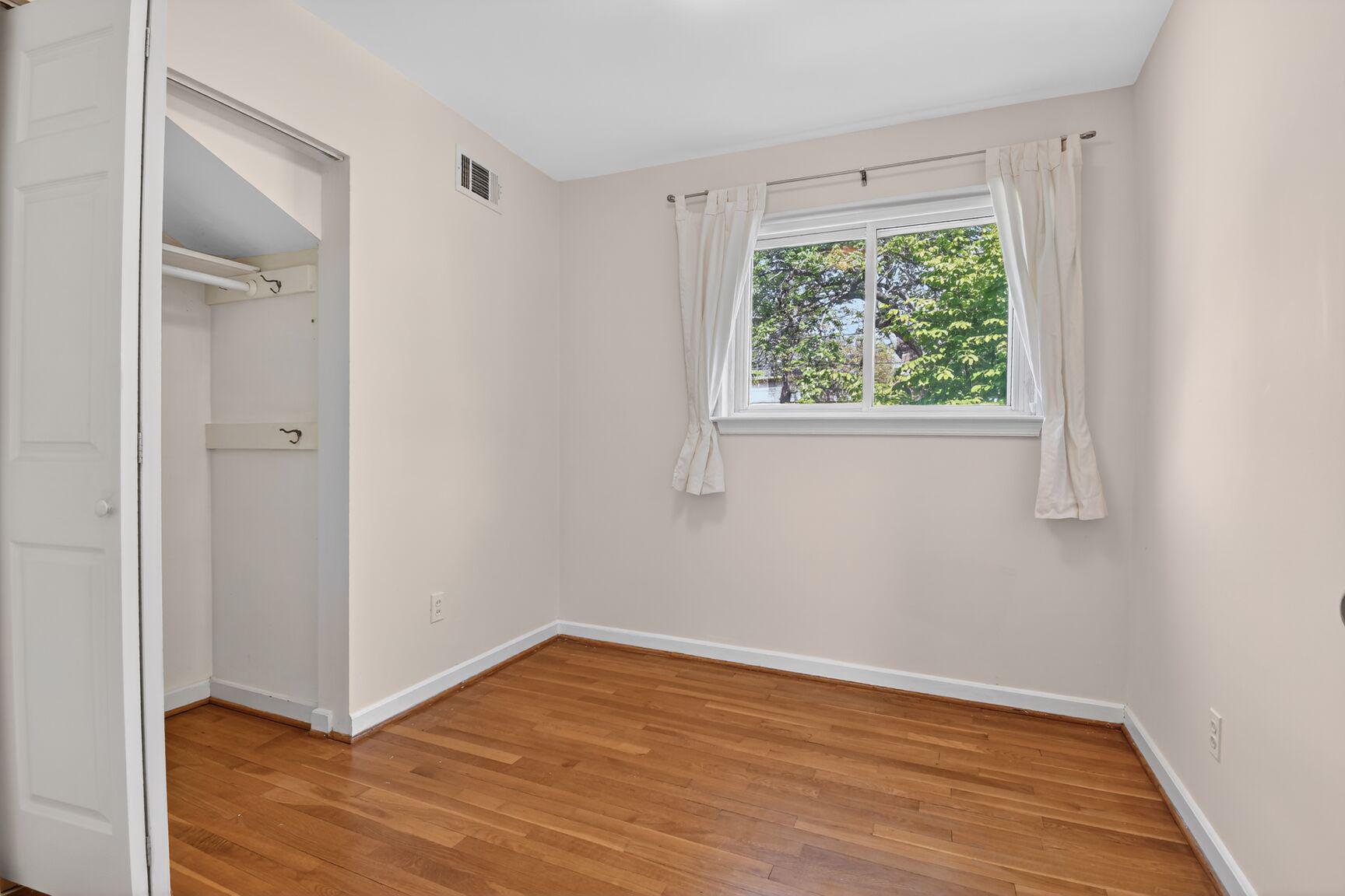 10226 Leslie Street Silver Spring, MD 20910 - Photo 17 of 32 a view of an empty room with wooden floor and a window
