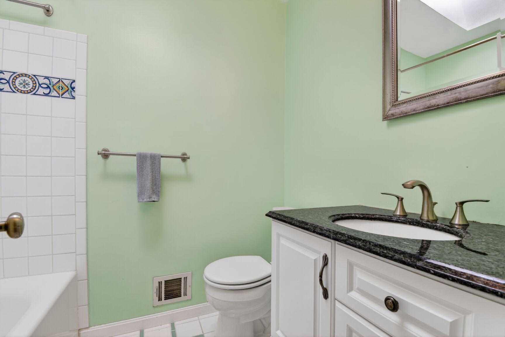 10226 Leslie Street Silver Spring, MD 20910 - Photo 18 of 32 a bathroom with a granite countertop sink and a toilet
