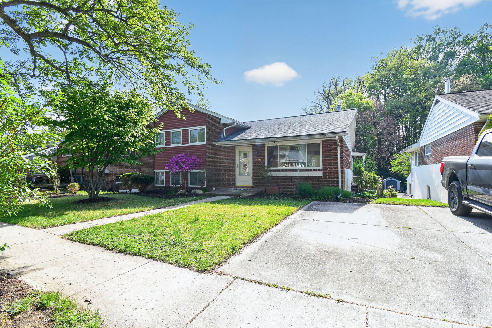 10226 Leslie Street Silver Spring, MD 20910 - Photo 2 of 32 a front view of a house with a yard and garage