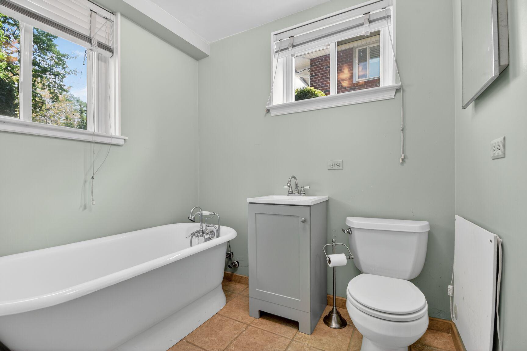 10226 Leslie Street Silver Spring, MD 20910 - Photo 22 of 32 a white toilet sitting next to a bath tub