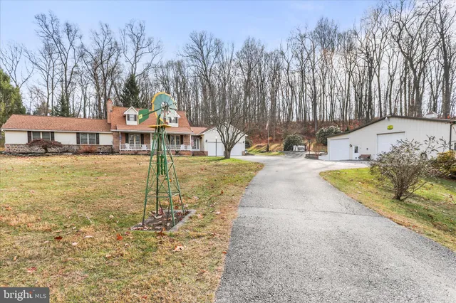 a living room with furniture ceiling fan and a window