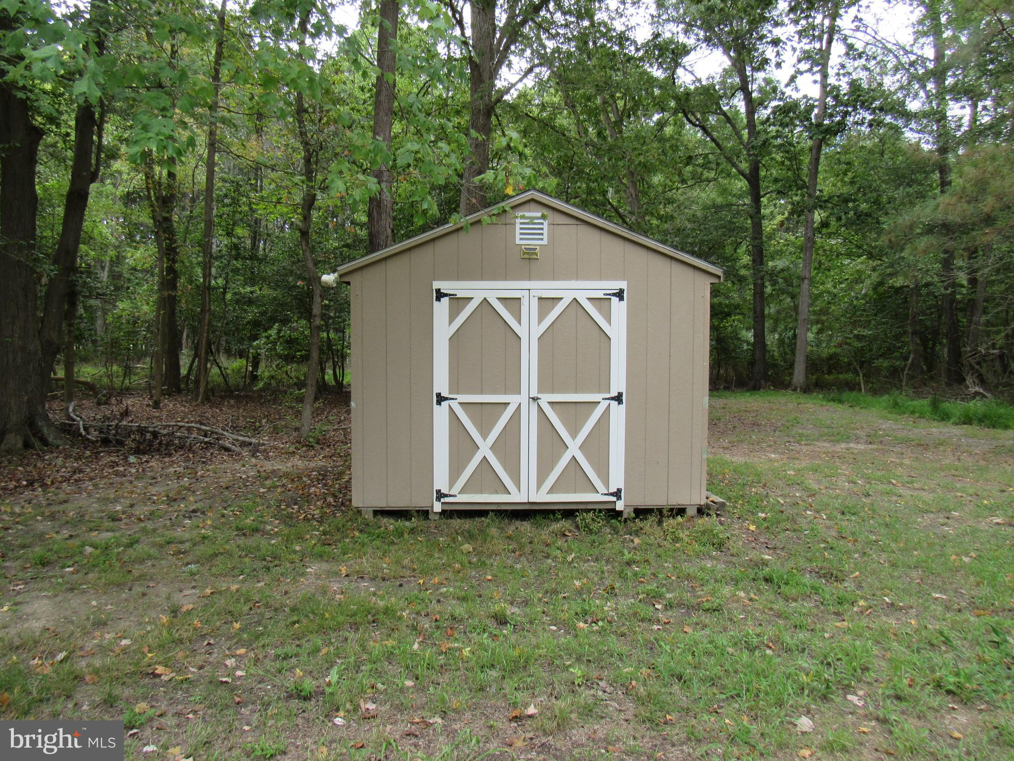 4420 Hooper Neck Road Taylors Island, MD 21669 - Photo 4 of 10 a house with green field in front of it