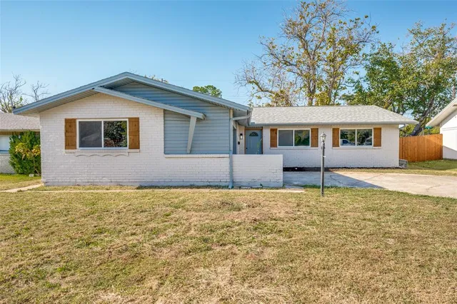 a house that has a tree in front of it