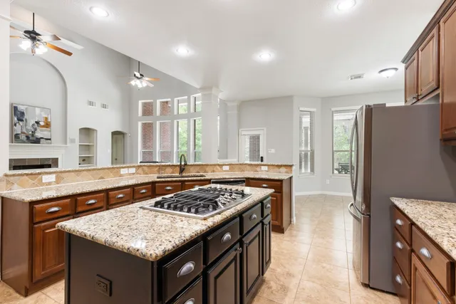 a bedroom with a bed couch and a large window