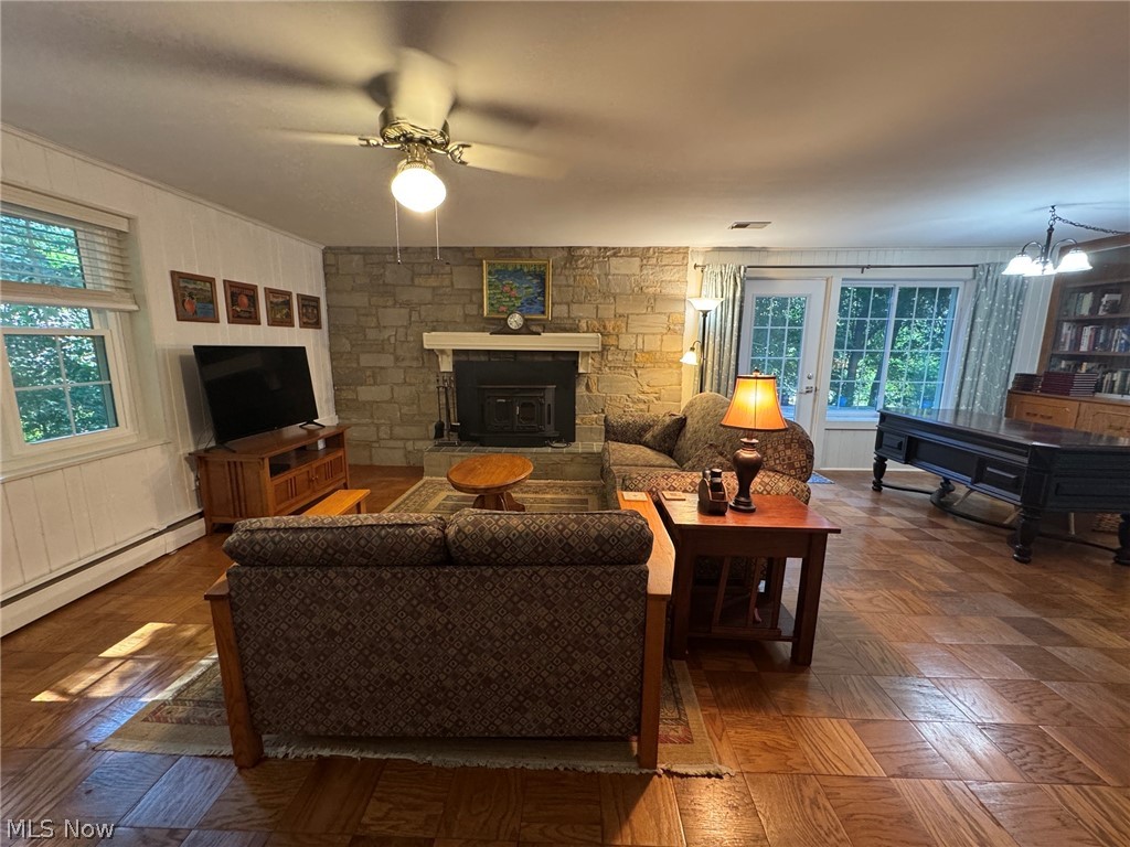 296 Fairfield Road Painesville, OH 44077 - Photo 12 of 48 Family room featuring a stone accent wall and access to the rear patio