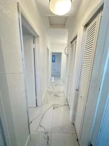 a view of a bathroom from a hallway